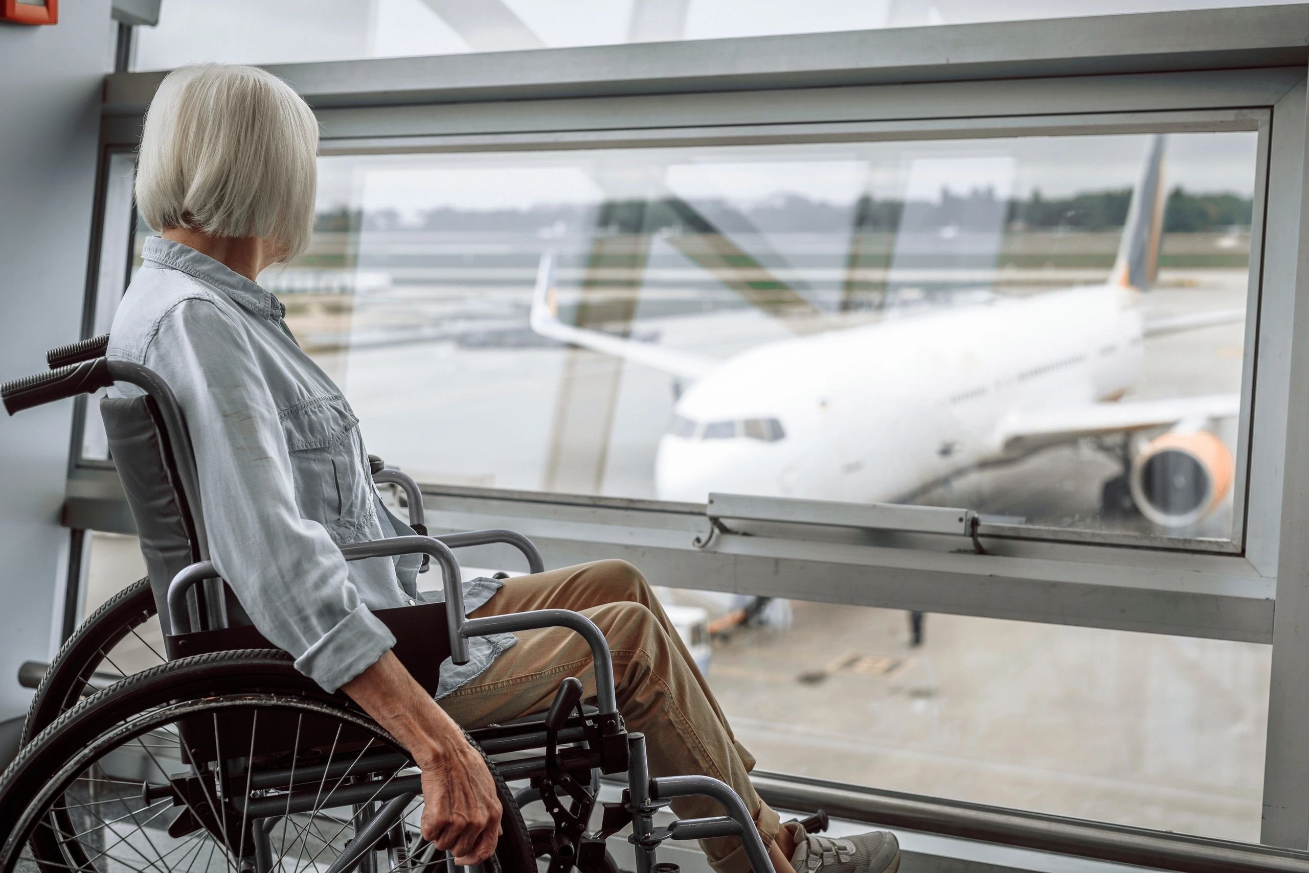 Senior traveler at airport window